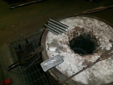 ingot and bars of aluminium on top of a crucible