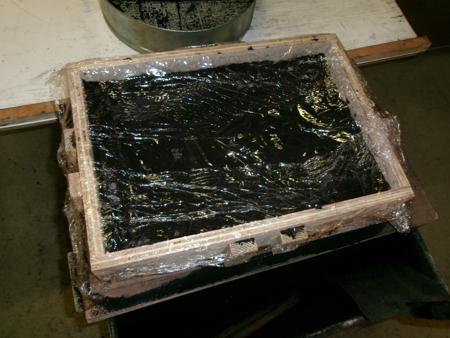 plastic film covering a box full of moist sand