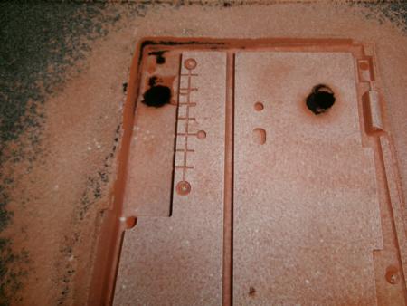 bottom half of keyboard mold in sand