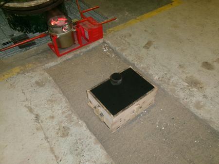 a mold on sand in front of a crucible