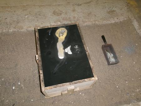 a mold with aluminium coming out of a riser hole