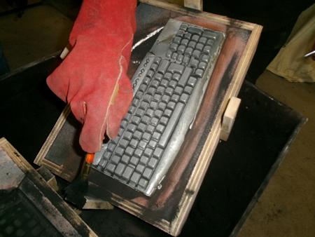 brushing away sand from between keys