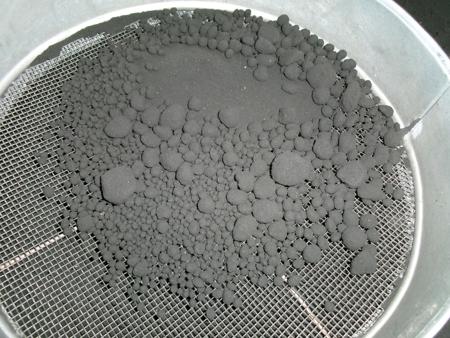 pebbles of sand in a sieve