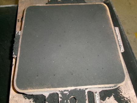 grid of holes in sand