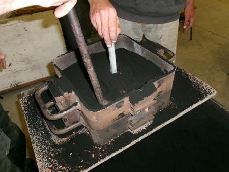 packing sand around pouring pipe
