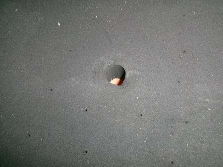 orange sand seen through pouring hole
