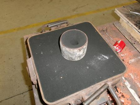 a pouring cup on top of the mold