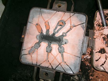 bottom half of first mold with scorched sand
